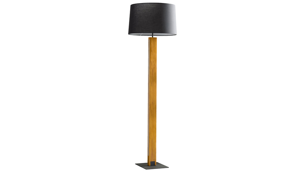 Stehlampe mit schwarzem Zylinderschirm, schlankem rechteckigem Holzstamm, sichtbarem Kabel und schwarzer quadratischer Metallbasis.