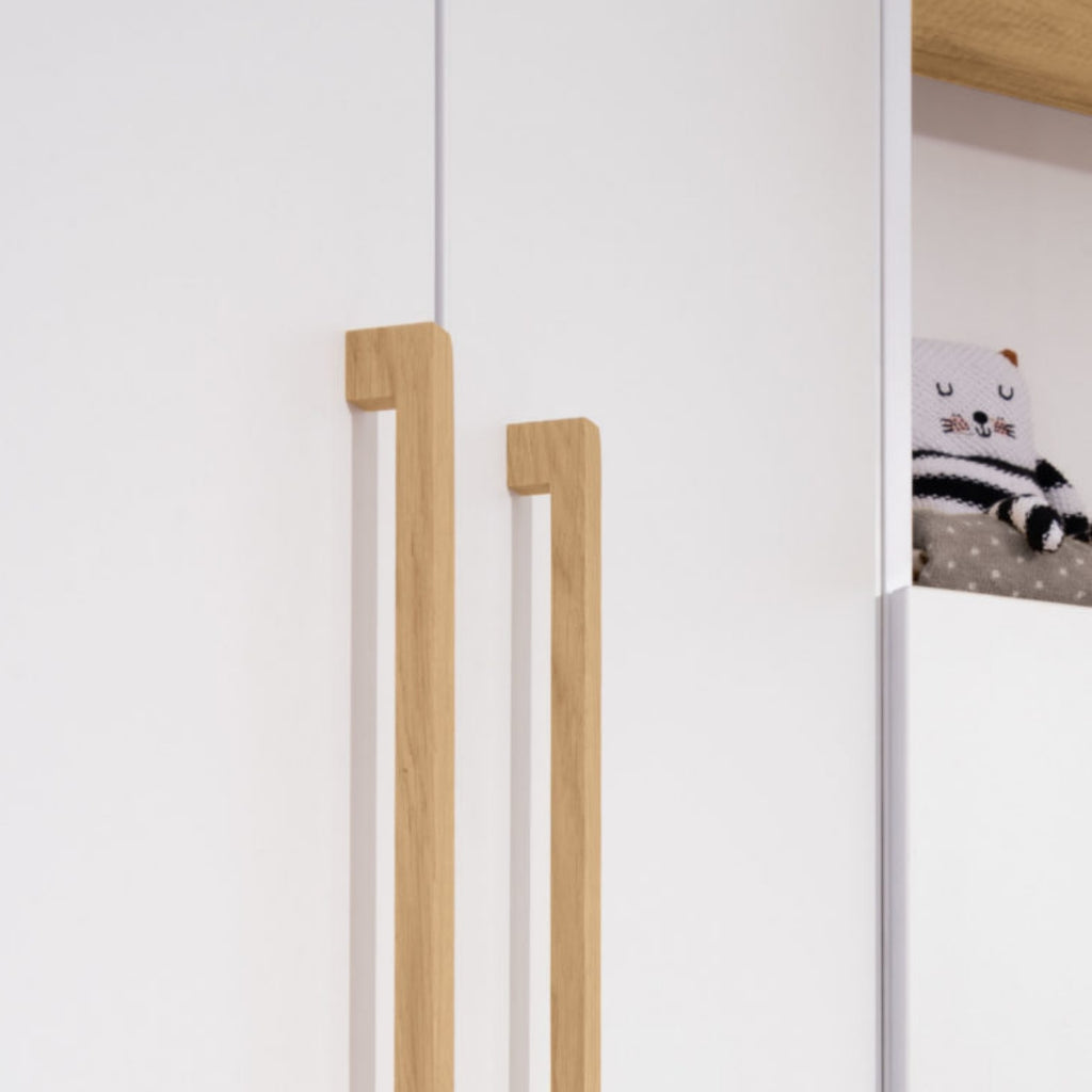 Weiße Türen, Holzgriffe, edle Akzente – der Kleiderschrank „Oscar“ aus dem PAIDI-Babyzimmerprogramm passt in jedes Baby- oder Kinderzimmer.